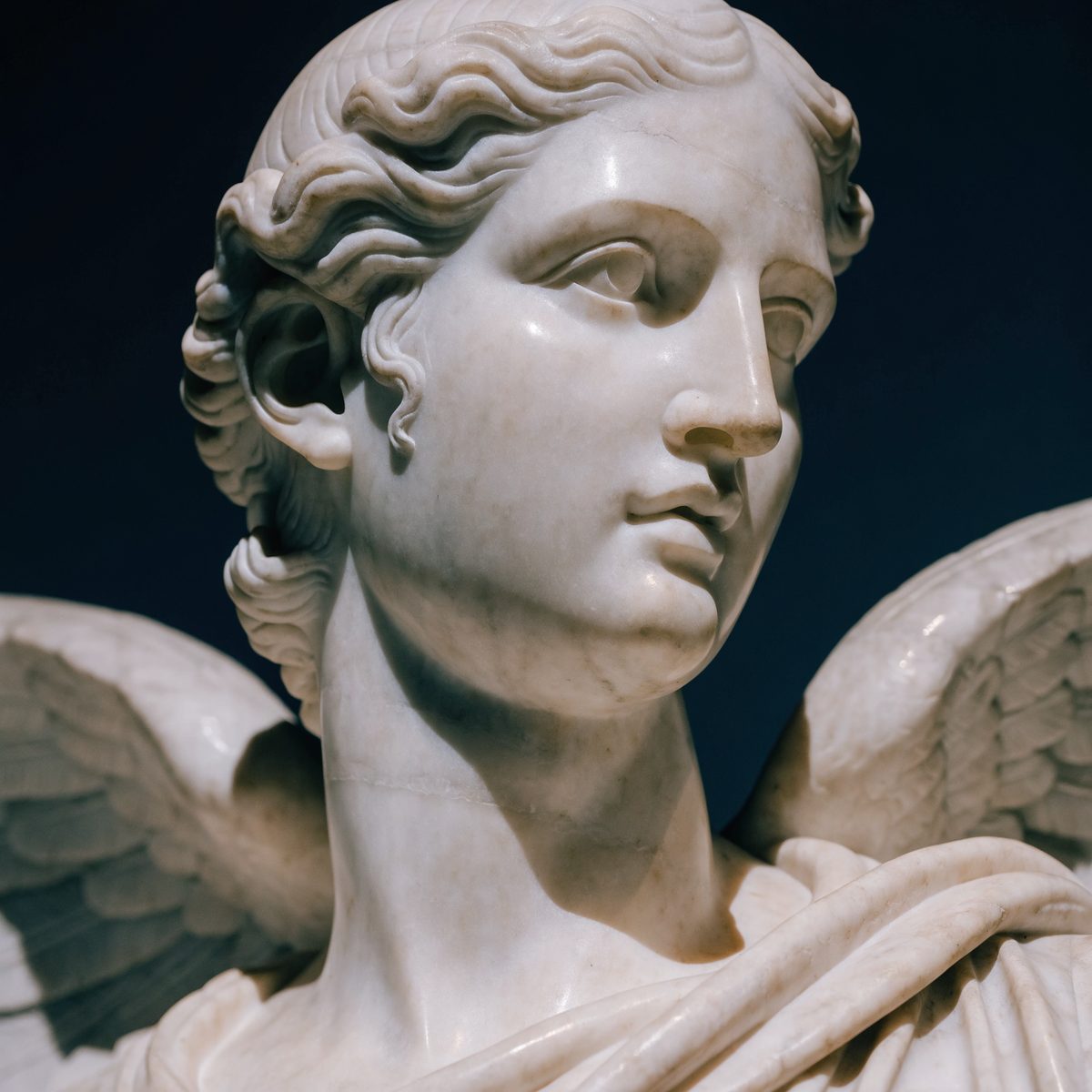 A classical marble sculpture of the Roman goddess Fama, winged